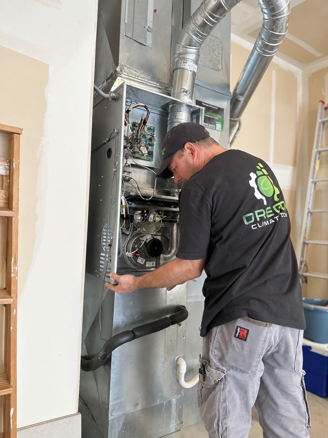 Technician inspecting an open furnace and ductwork